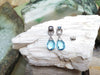 SJ2100 - Blue Topaz with Diamond Earrings Set in 18 Karat White Gold Settings