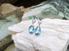 SJ2100 - Blue Topaz with Diamond Earrings Set in 18 Karat White Gold Settings