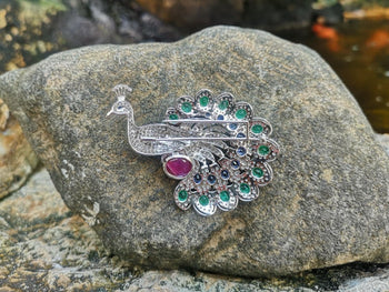 JP0046R - Diamond, Emerald, Ruby, and Blue Sapphire Peacock Brooch Set in 18K White Gold Setting